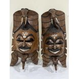 Two similar African carved hardwood masks with bone inlay and tusks. 35' high approx.