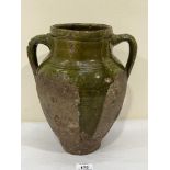 A Tudor green ware two handled jar, part glazed on a buff pottery fabric. Surrey, Hampshire