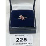 A 9ct ruby and diamond cross-over ring. 2g gross. Size M. One setting vacant