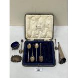 A part set of cased silver coffee spoons; a silver reticulated salt; a silver posy holder; a