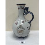 An 18th century Chinese export famille-rose ewer with sinuous dragon handle, painted with