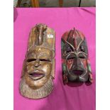 Two African carved wood masks, the larger 19' high
