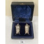 A cased pair of Edward VII silver pepperettes. Sheffield 1906. 1oz 19dwts