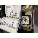 An album of postage stamps and a box of loose stamps