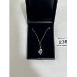 A 14ct blue topaz and diamond heart pendant on 9ct necklet chain. 1.7g gross