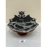 A Papua New Guinea earthenware bowl with stylised anthropomorphic decoration. 9' wide