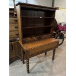 An oak open bookcase with two adjustable shelves over a pair of drawers raised on dropleaf table