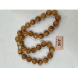 A necklace of amber beads. 25' long. 75g