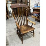 A Victorian lath-back armchair. Legs reduced, losses and damage to arm