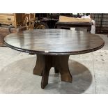 A pine dining table on cruciform base. 60' diam.