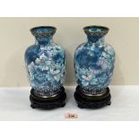 A pair of Japanese cloisonne enamel vases on wood stands. The vases 8' high