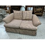 A two seater sofa upholstered in check fabric. 62' wide