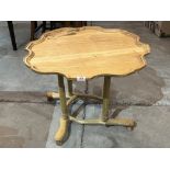 An unusual light oak low table, the shaped piecrust top carved with a Mallard. 29' diam.