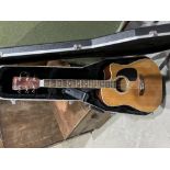 A Woodstock acoustic guitar, cut-away body, with strap and hard case. 41' long