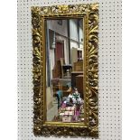 A carved giltwood wall mirror. 26½' x 13½'