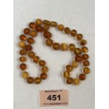 A necklace of clear and clouded amber beads. The string 17' long approx. 20g