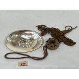 A silver rimmed mother-of-pearl shell with blister pearls, 6' wide; together with an Austrian gemset