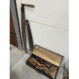 A tool chest with tools and two saws