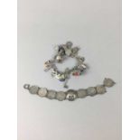 A SILVER CHARM BRACELET AND ANOTHER