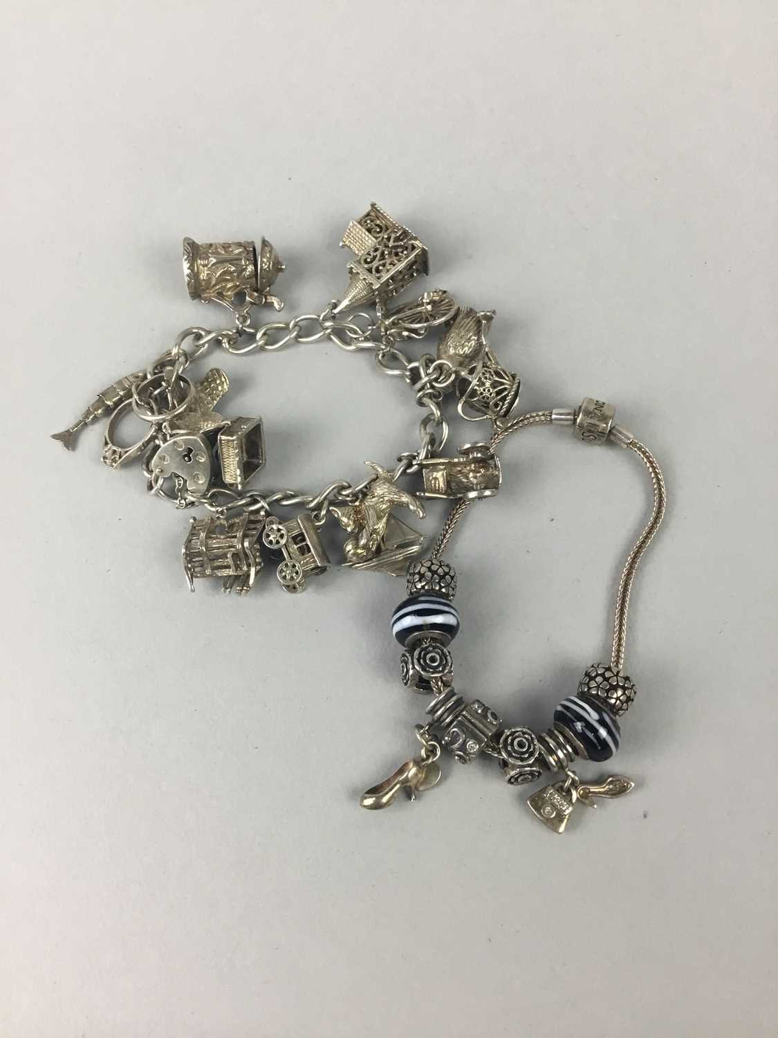 A SILVER CHARM BRACELET AND ANOTHER