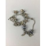 A SILVER CHARM BRACELET AND ANOTHER