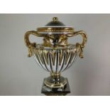 AN ITALIAN SILVER LEAF AND GILT POTTERY AMPHORA SHAPED URN ON STAND