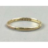 A NINE CARAT GOLD WEDDING RING