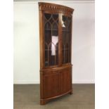 A REPRODUCTION YEW WOOD BOW FRONTED CORNER DISPLAY CABINET