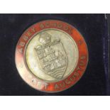 A SILVER GILT 'OPERATION DESERT STORM' RING ALONG WITH SILVER ENAMELLED SCHOLASTIC MEDAL