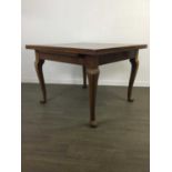 A WALNUT PULLOUT EXTENDING DINING TABLE WITH FOUR CHAIRS