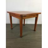 AN OAK PULLOUT EXTENDING DINING TABLE