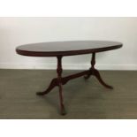 AN OVAL MAHOGANY COFFEE TABLE