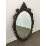 AN OVAL BEVELLED WALL MIRROR