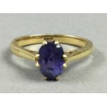 A PURPLE GEM SET RING