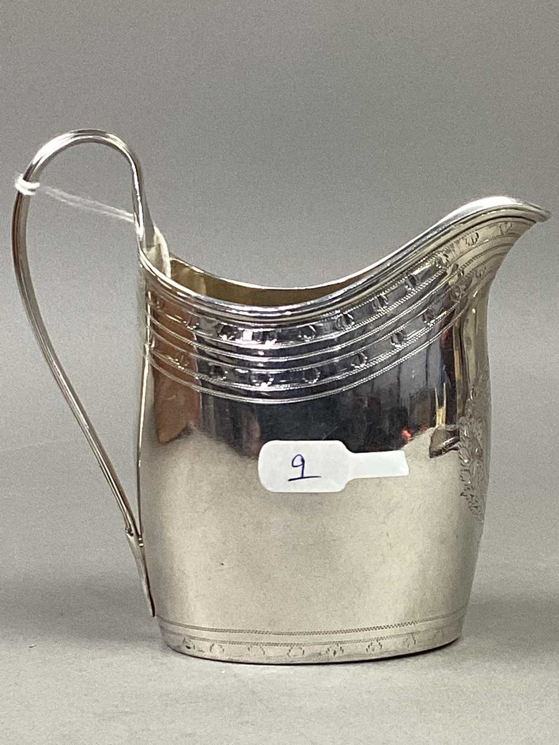 A GEORGE III SILVER CREAM JUG