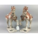 A PAIR OF TANG STYLE EARTHENWARE HORSES