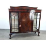 A MAHOGANY BOW FRONTED THREE DOOR DISPLAY CABINET