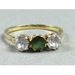 A GREEN AND WHITE GEM SET RING