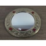 A CIRCULAR WALL MIRROR OF ARTS & CRAFTS DESIGN