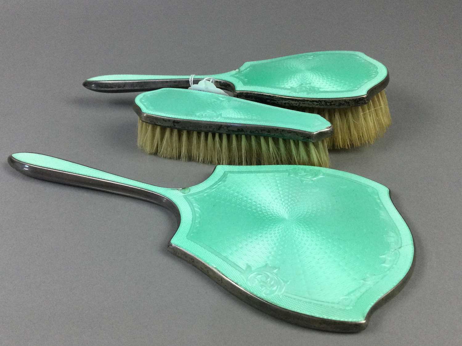 AN EARLY 20TH CENTURY SILVER AND GREEN GUILLOCHE ENAMEL VANITY SET