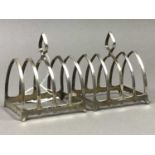 A PAIR OF SILVER TOAST RACKS, CRUET SET, NAPKIN RING AND RATTLE