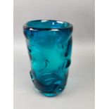 A SWIRL MOULDED BLUE GLASS VASE