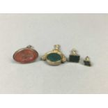 A VICTORIAN SWIVEL FOB AND THREE FURTHER FOBS