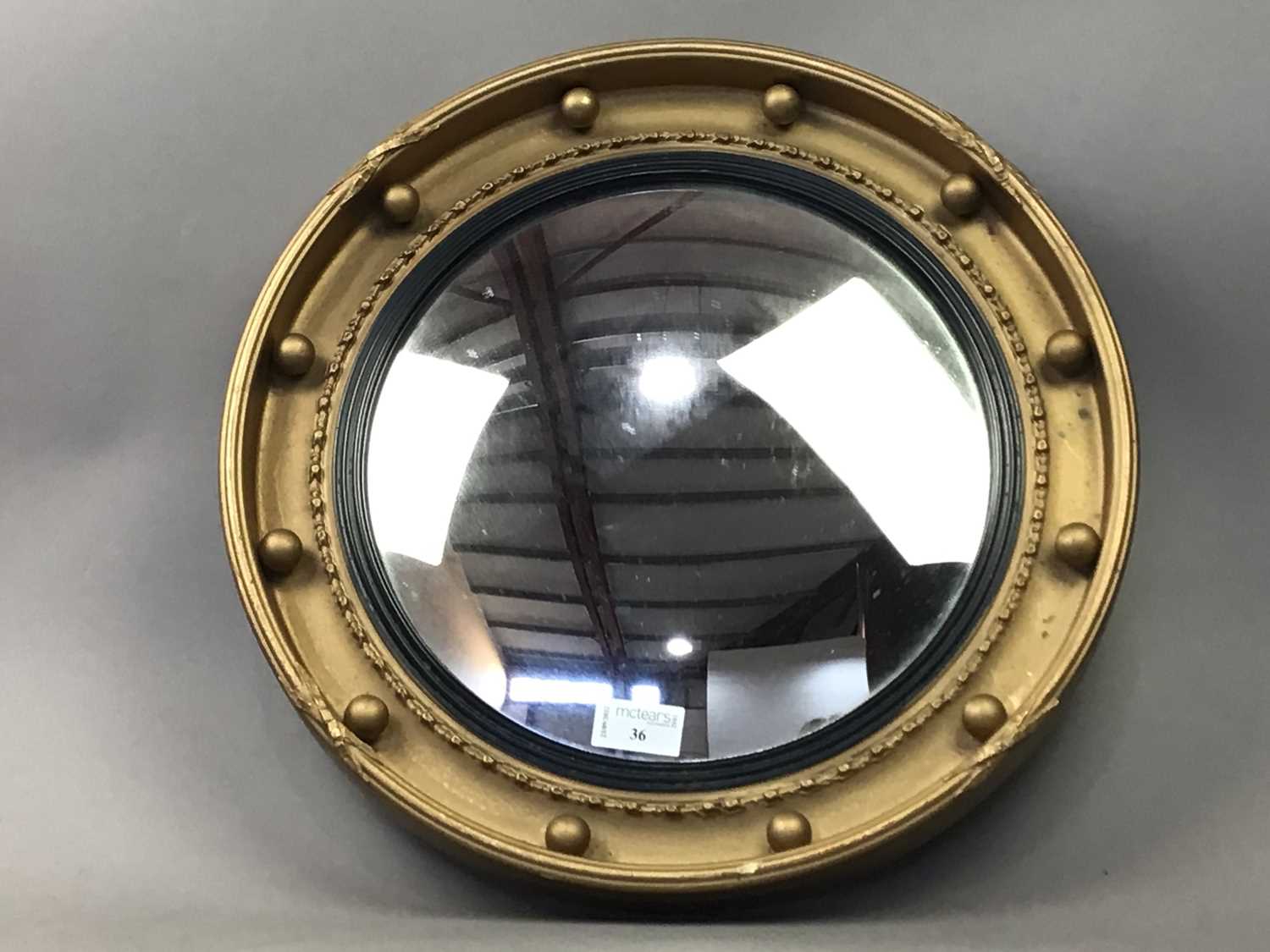 A GILT FRAMED CONVEX MIRROR