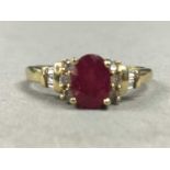 A NINE CARAT GOLD RUBY AND DAMOND RING