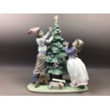 A LLADRO FIGURE GROUP OF BOY AND GIRL DECORATING A CHRISTMAS TREE