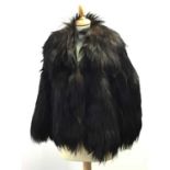 A BEAR FUR CAPE, ALONG WITH OTHER FURS