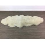 A DOUBLE SHEEP SKIN RUG