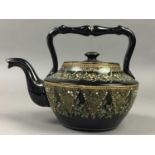 A VICTORIAN BLACK PAINTED TEA POT, ALONG WITH OTHER TEA POTS AND JUGS