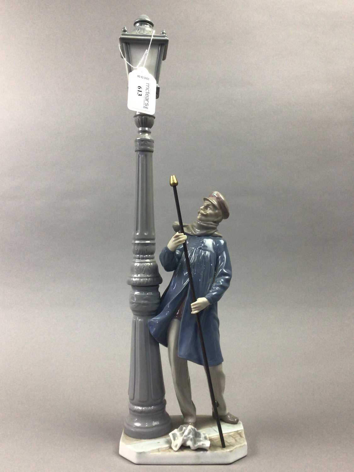 A LLADRO FIGURE OF A LAMPLIGHTER